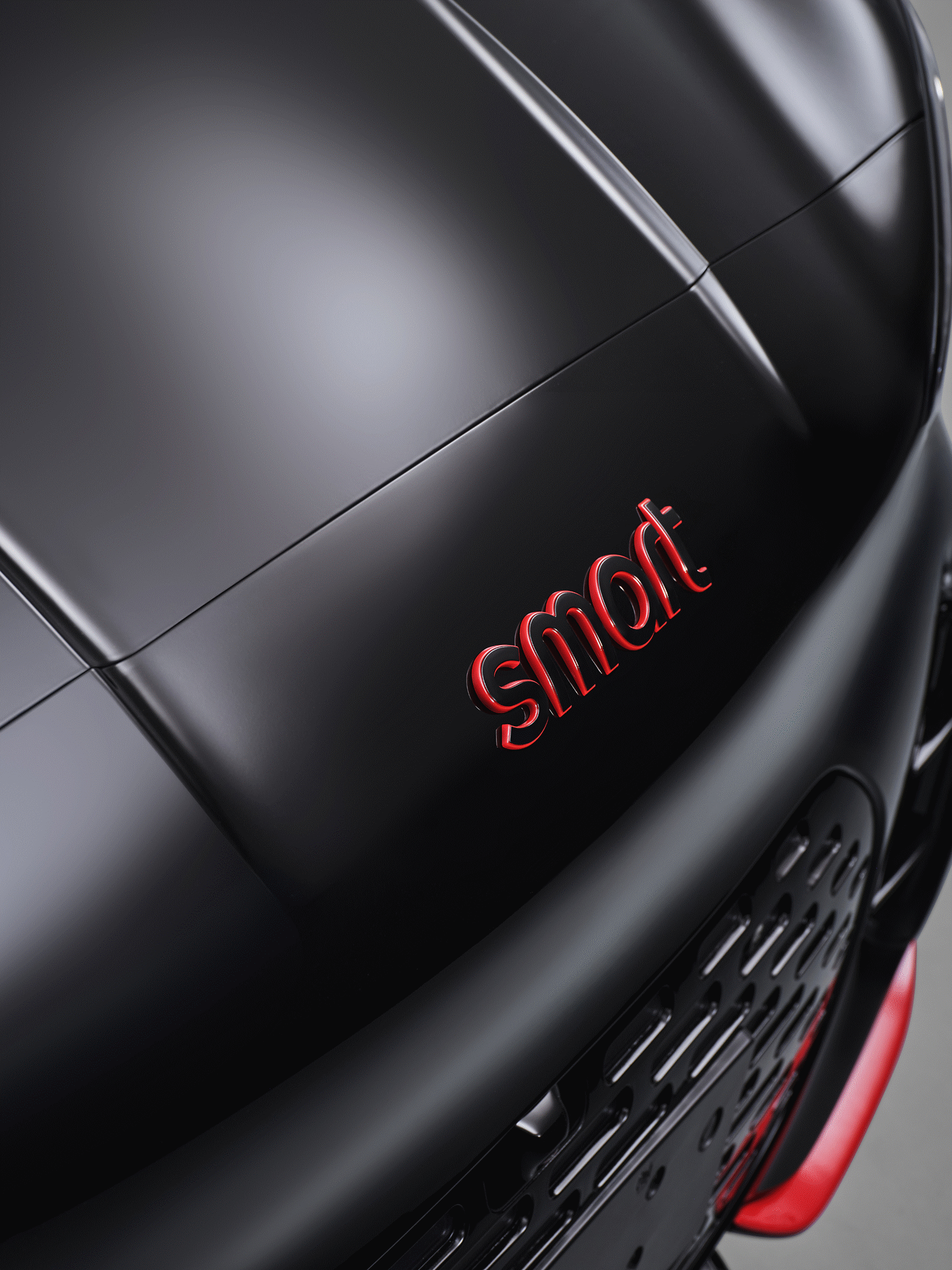 Primer plano del capó de un smart #2 BRABUS negro con el logotipo «smart» en rojo y detalles rojos en el faldón delantero.