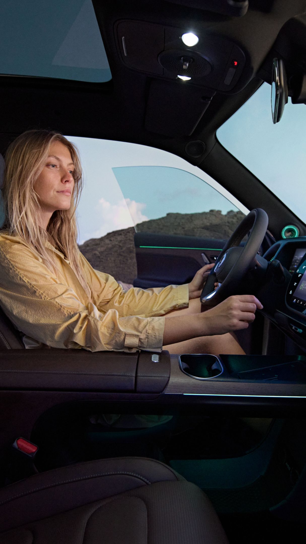 A woman sitting in the driver's seat of the smart #5.