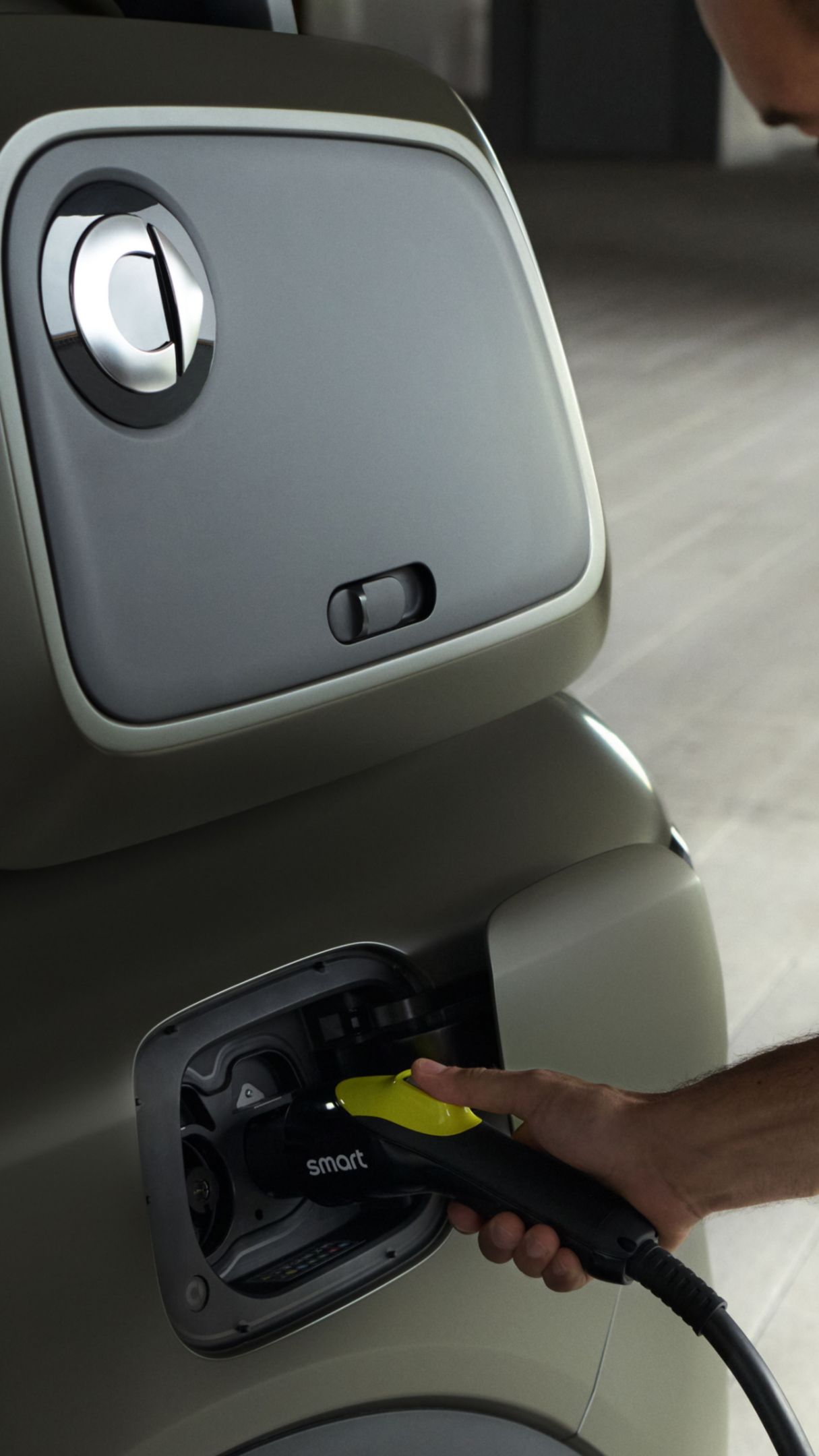 A man in a yellow shirt charging his smart #5.
