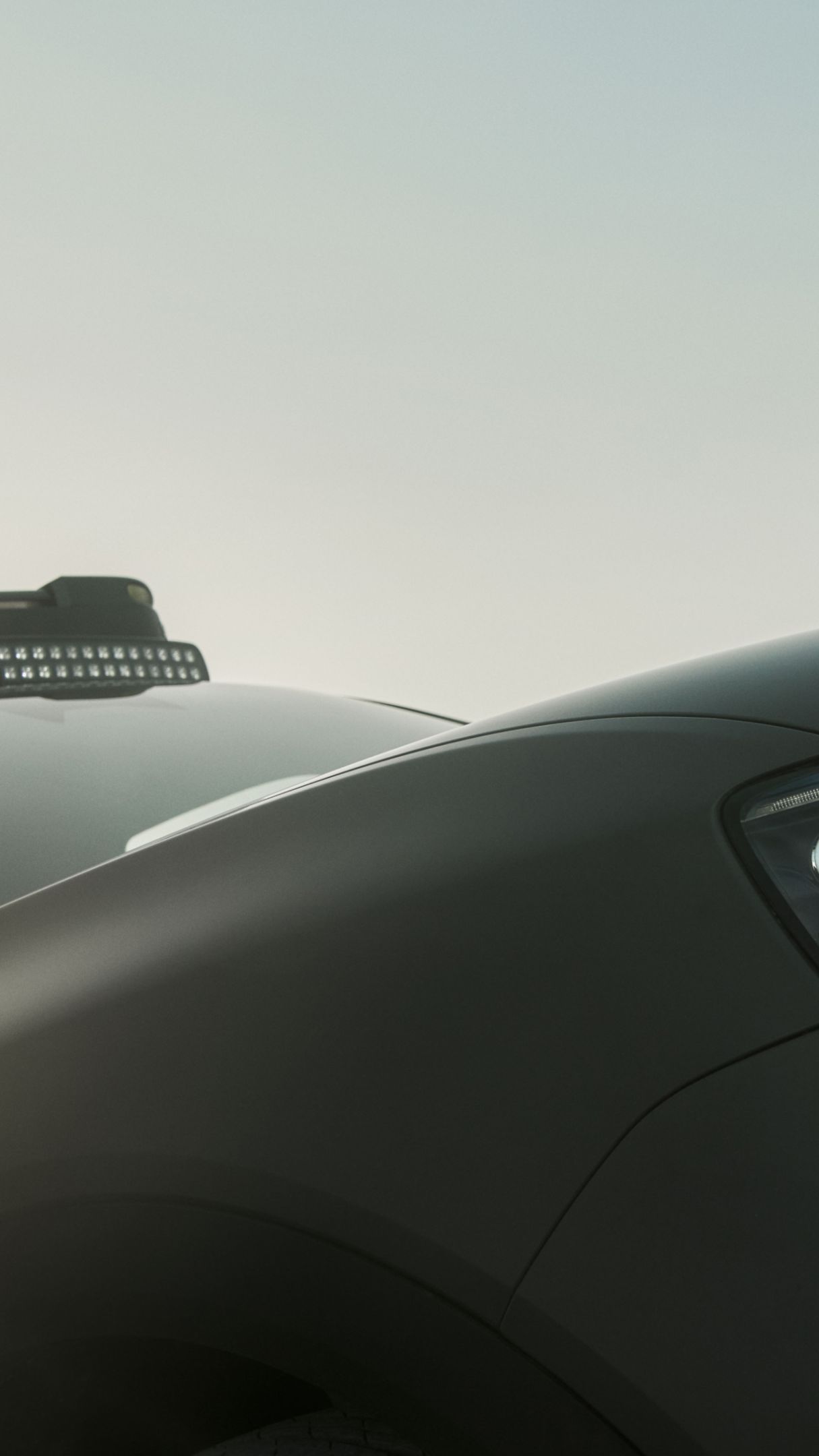 A close-up of the smart #5 with its lights on.